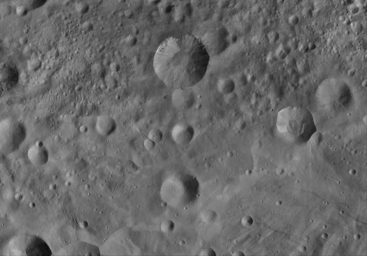 This image of Numisia AV-L-21, from the atlas of the giant asteroid Vesta, was created from images taken as NASA Dawn mission flew around the object, also known as a protoplanet. The set of maps was created from mosaics of10,000 images from Dawn's framing camera instrument, taken at a low altitude of about 130 miles (210 kilometers). This map is mostly at a scale about that of regional road touring maps, where every inch of map is equivalent to a little more than 3 miles of asteroid (one centimeter equals 2 kilometers). http://photojournal.jpl.nasa.gov/catalog/PIA19525
