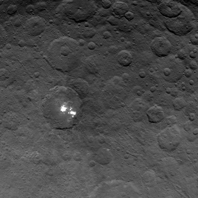 The brightest spots on dwarf planet Ceres are seen in this image taken by NASA's Dawn spacecraft on June 6, 2015. This is among the first snapshots from Dawn's second mapping orbit, which is 2,700 miles (4,400 kilometers) in altitude. The resolution is 1,400 feet (410 meters) per pixel. Scientists are still puzzled by the nature of these spots, and are considering explanations that include salt and ice. http://photojournal.jpl.nasa.gov/catalog/PIA19568
