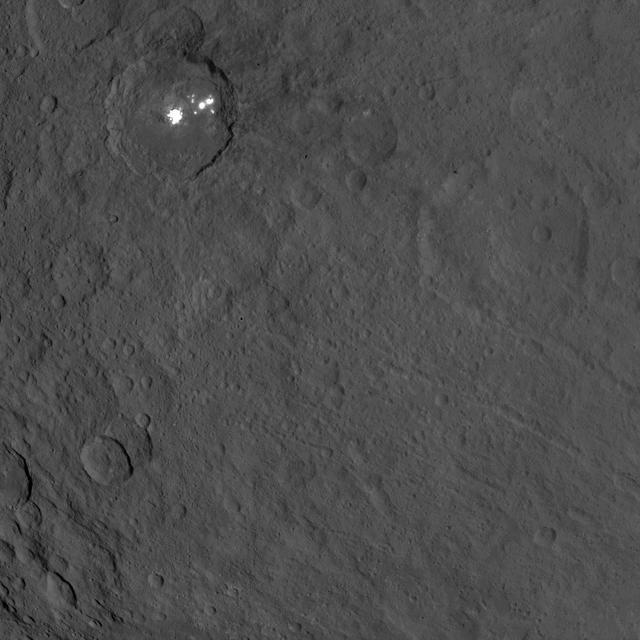 This image, taken by NASA's Dawn spacecraft, shows the bright spots of Occator crater on Ceres from an altitude of 2,700 miles (4,400 kilometers). The image, with a resolution of 1,400 feet (410 meters) per pixel, was taken on June 25, 2015.   http://photojournal.jpl.nasa.gov/catalog/PIA19630