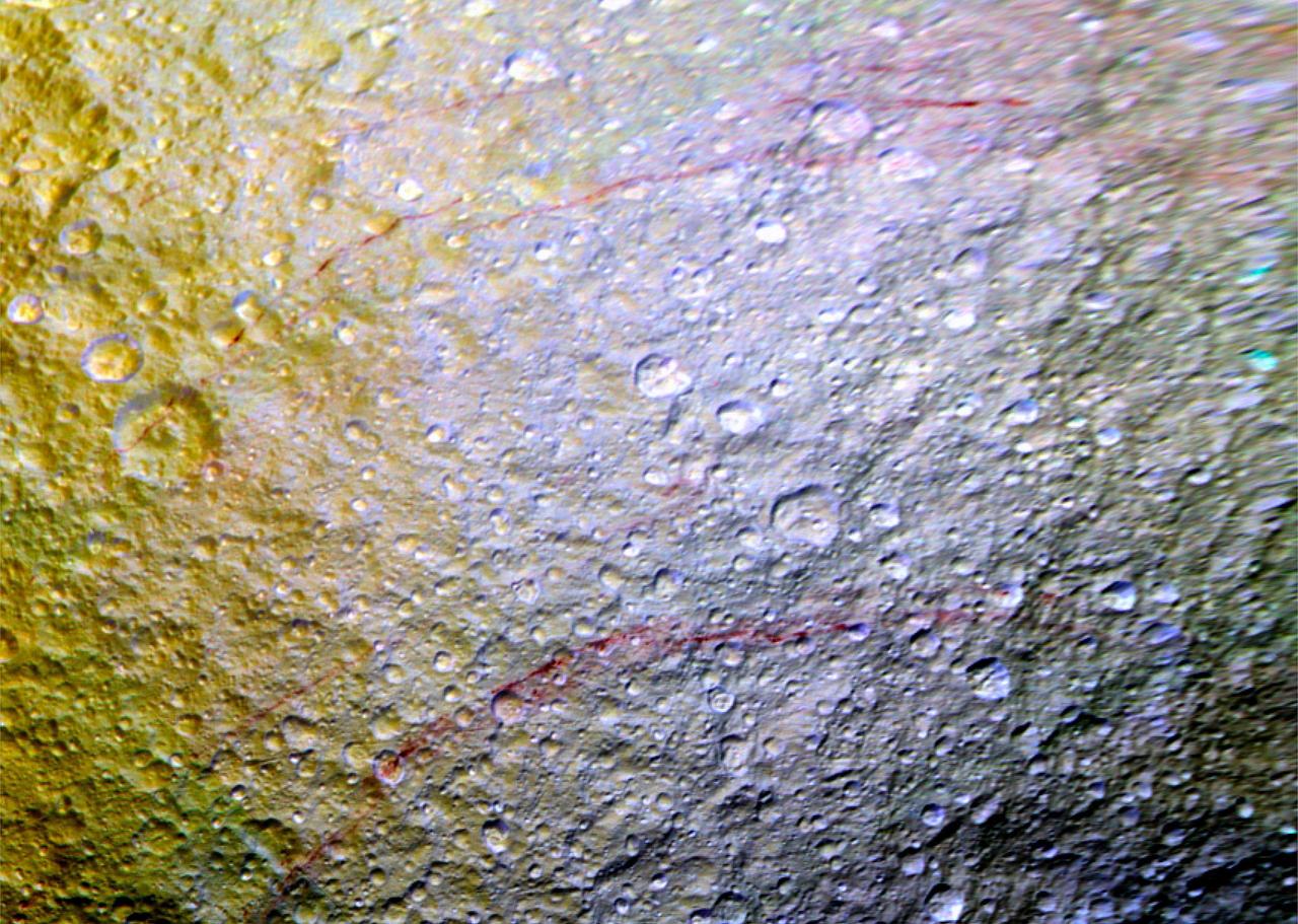 Unusual arc-shaped, reddish streaks cut across the surface of Saturn's ice-rich moon Tethys in this enhanced-color mosaic. The red streaks are narrow, curved lines on the moon's surface, only a few miles (or kilometers) wide but several hundred miles (or kilometers) long. The red streaks are among the most unusual color features on Saturn's moons to be revealed by Cassini's cameras. A few of the red arcs can be faintly seen in Cassini imaging observations made earlier in the mission, but the color images for this observation, which were obtained in April 2015, were the first to show large northern areas of Tethys under the illumination and viewing conditions necessary to see the features clearly. As the Saturn system moved into its northern hemisphere summer over the past few years, northern latitudes have become increasingly well illuminated. As a result, the red arc features have become clearly visible for the first time. The origin of the features and their reddish color is currently a mystery to Cassini scientists. Possibilities being studied include ideas that the reddish material is exposed ice with chemical impurities, or the result of outgassing from inside Tethys. The streaks could also be associated with features like fractures that are below the resolution of the available images. Except for a few small craters on Dione, reddish tinted features are rare on other moons of Saturn. However, many reddish features are observed on the geologically young surface of Jupiter's moon Europa. Images taken using clear, green, infrared and ultraviolet spectral filters were combined to create the view, which highlights subtle color differences across Tethys' surface at wavelengths not visible to human eyes. The moon's surface is fairly uniform in natural color. The yellowish tones on the left side of the view are a result of alteration of the moon's surface by high-energy particles from Saturn's magnetosphere. This particle radiation slams into the moon's trailing hemisphere, modifying it chemically and changing its appearance in enhanced-color views like this one. The area of Tethys shown here is centered on 30 degrees north latitude, 187 degrees west longitude, and measures 305 by 258 miles (490 by 415 kilometers) across. The original color images were obtained at a resolution of about 2,300 feet (700 meters) per pixel on April 11, 2015. This is a cropped close-up of an area visible in PIA19636. This is a mosaic of images that have been photometrically calibrated and map-projected. http://photojournal.jpl.nasa.gov/catalog/PIA19637