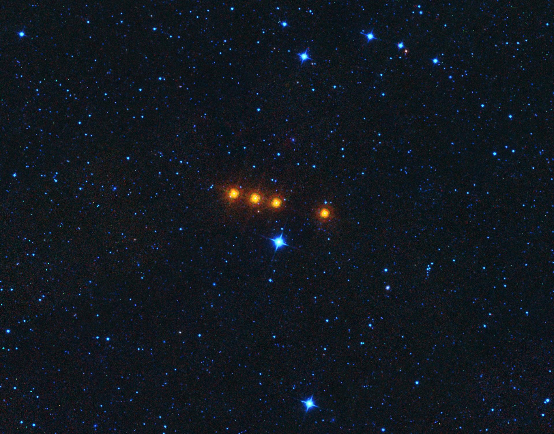 The asteroid Euphrosyne glides across a field of background stars in this time-lapse view from NASA WISE spacecraft. Euphrosyne is quite dark in visible light, but glows brightly at infrared wavelengths.