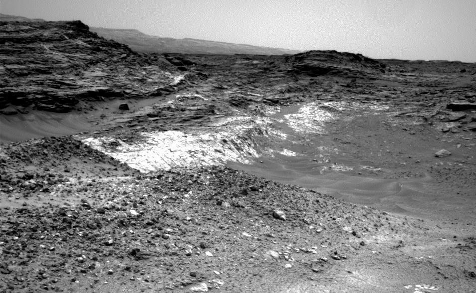 The Martian outcrop where pale rock meets darker overlying rock near the middle of this view is an example of a geological contact. Such contacts can reveal clues about how the environmental conditions that produced one type of rock were related to the conditions that produced the other.  NASA's Curiosity Mars rover took this image with its Navigation Camera (Navcam) just after finishing an uphill drive of about 72 feet (22 meters) on the 991st Martian day, or sol of the rover's work on Mars (May 21, 2015).   http://photojournal.jpl.nasa.gov/catalog/PIA19663