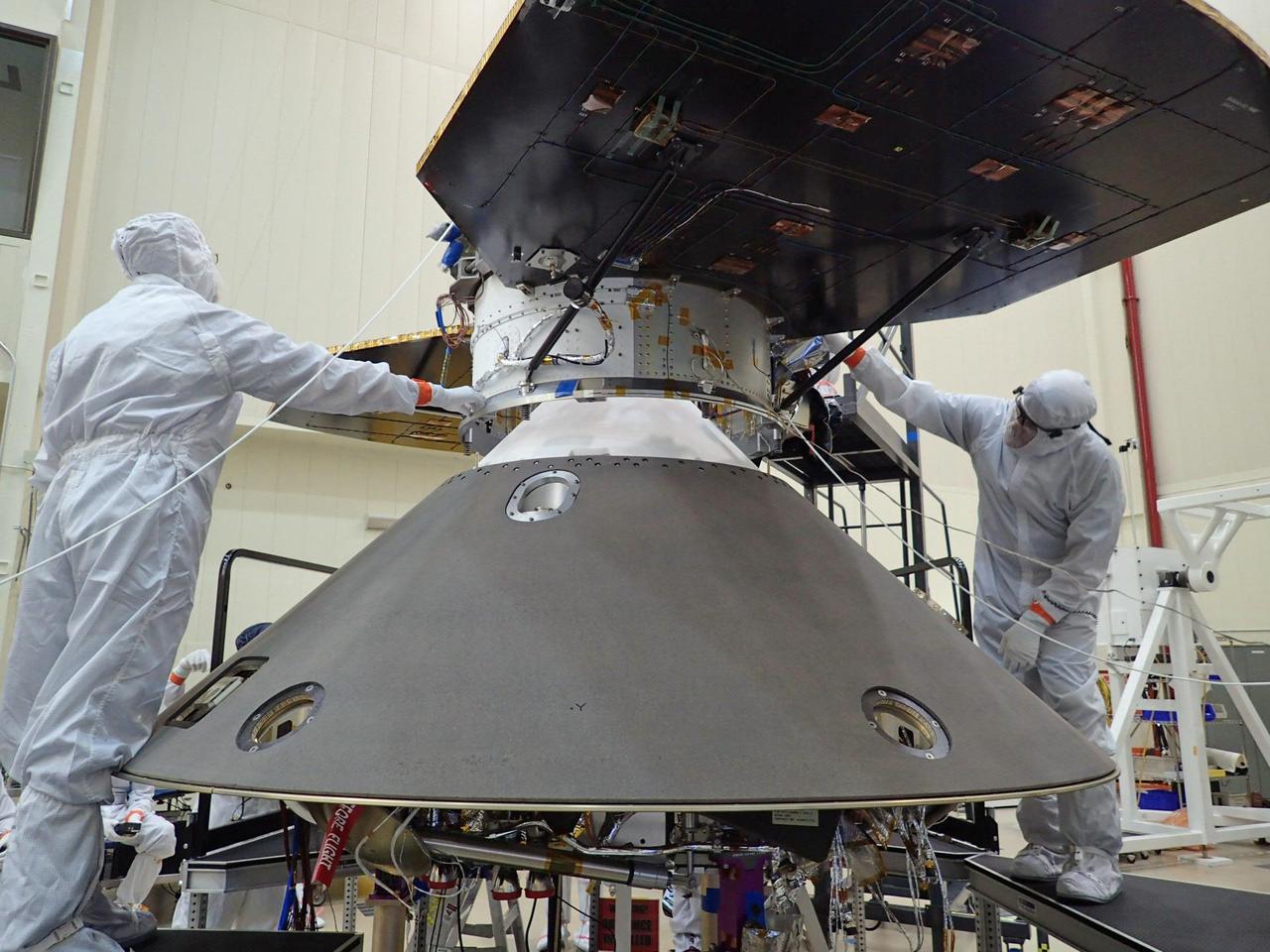 Spacecraft specialists at Lockheed Martin Space Systems, Denver, are preparing to attach the cruise stage of NASA's InSight spacecraft to the top of the spacecraft's back shell in this April 29, 2015, photo. The cruise stage will serve multiple functions during the flight from Earth to Mars. It has its own solar arrays, thrusters and radio antennas. It will be jettisoned shortly before the spacecraft enters the Martian atmosphere. InSight, for Interior Exploration Using Seismic Investigations, Geodesy and Heat Transport, is scheduled for launch in March 2016 and landing in September 2016. It will study the deep interior of Mars to advance understanding of the early history of all rocky planets, including Earth. Note: After thorough examination, NASA managers have decided to suspend the planned March 2016 launch of the Interior Exploration using Seismic Investigations Geodesy and Heat Transport (InSight) mission. The decision follows unsuccessful attempts to repair a leak in a section of the prime instrument in the science payload. http://photojournal.jpl.nasa.gov/catalog/PIA19667