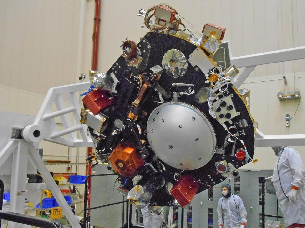 The science deck of NASA's InSight lander is being turned over in this April 29, 2015, photo from InSight assembly and testing operations inside a clean room at Lockheed Martin Space Systems, Denver. The large circular component on the deck is the protective covering to be placed over InSight's seismometer after the seismometer is placed directly onto the Martian ground.  InSight, for Interior Exploration Using Seismic Investigations, Geodesy and Heat Transport, is scheduled for launch in March 2016 and landing in September 2016. It will study the deep interior of Mars to advance understanding of the early history of all rocky planets, including Earth.  Note: After thorough examination, NASA managers have decided to suspend the planned March 2016 launch of the Interior Exploration using Seismic Investigations Geodesy and Heat Transport (InSight) mission. The decision follows unsuccessful attempts to repair a leak in a section of the prime instrument in the science payload.  http://photojournal.jpl.nasa.gov/catalog/PIA19670