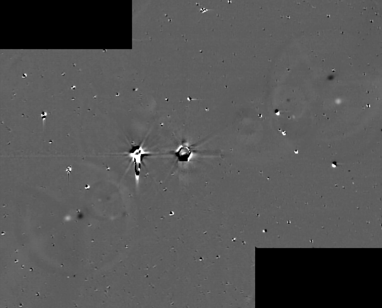 This illustration shows some of the final images used to determine that the coast is clear for New Horizons' flight through the Pluto system. These images show the difference between two sets of 48 combined 10-second exposures with New Horizons Long Range Reconnaissance Imager (LORRI) camera, taken at 8:40 UTC and 10:25 UTC on June 26, 2015, from a range of 21.5 million kilometers (approximately 13 million miles) to Pluto. The known small moons, Nix, Hydra, Kerberos and Styx, are visible as adjacent bright and dark pairs of dots, due to their motion in the 105 minutes between the two image sets. The images have been extensively processed to remove the glare and "ghosts" (i.e., lens flare) from Pluto and Charon, and also to remove background stars, though many of the brighter stars are imperfectly removed and appear as irregular bright and dark blobs. These and other similar sets of images demonstrate that there are no previously unknown moons brighter than 15 times fainter than Styx (the faintest known moon) in the region outside of Charon's orbit, or brighter than five times fainter than Styx in the region between Charon's orbit and a few thousand kilometers above Pluto's surface. http://photojournal.jpl.nasa.gov/catalog/PIA19695