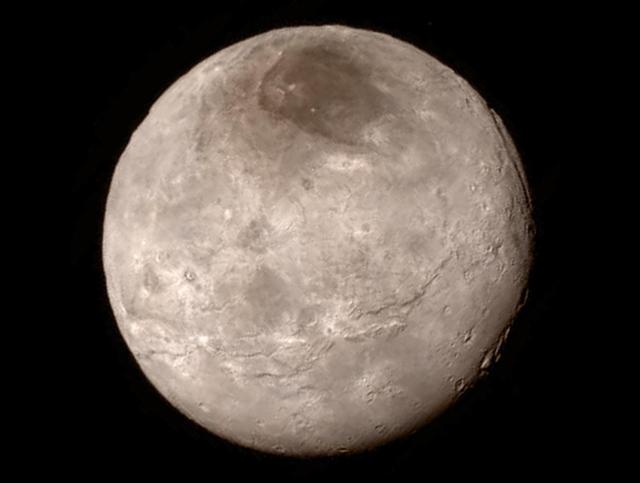 Remarkable new details of Pluto's largest moon Charon are revealed in this image from New Horizons' Long Range Reconnaissance Imager (LORRI), taken late on July 13, 2015 from a distance of 289,000 miles (466,000 kilometers).  A swath of cliffs and troughs stretches about 600 miles (1,000 kilometers) from left to right, suggesting widespread fracturing of Charon's crust, likely a result of internal processes. At upper right, along the moon's curving edge, is a canyon estimated to be 4 to 6 miles (7 to 9 kilometers) deep.  Mission scientists are surprised by the apparent lack of craters on Charon. South of the moon's equator, at the bottom of this image, terrain is lit by the slanting rays of the sun, creating shadows that make it easier to distinguish topography. Even here, however, relatively few craters are visible, indicating a relatively young surface that has been reshaped by geologic activity.  In Charon's north polar region, a dark marking prominent in New Horizons' approach images is now seen to have a diffuse boundary, suggesting it is a thin deposit of dark material. Underlying it is a distinct, sharply bounded, angular feature; higher resolution images still to come are expected to shed more light on this enigmatic region.  The image has been compressed to reduce its file size for transmission to Earth. In high-contrast areas of the image, features as small as 3 miles (5 kilometers) across can be seen. Some lower-contrast detail is obscured by the compression of the image, which may make some areas appear smoother than they really are. The uncompressed version still resides in New Horizons' computer memory and is scheduled to be transmitted at a later date.  The image has been combined with color information obtained by New Horizons' Ralph instrument on July 13.  New Horizons traveled more than three billion miles over nine-and-a-half years to reach the Pluto system.  http://photojournal.jpl.nasa.gov/catalog/PIA19709