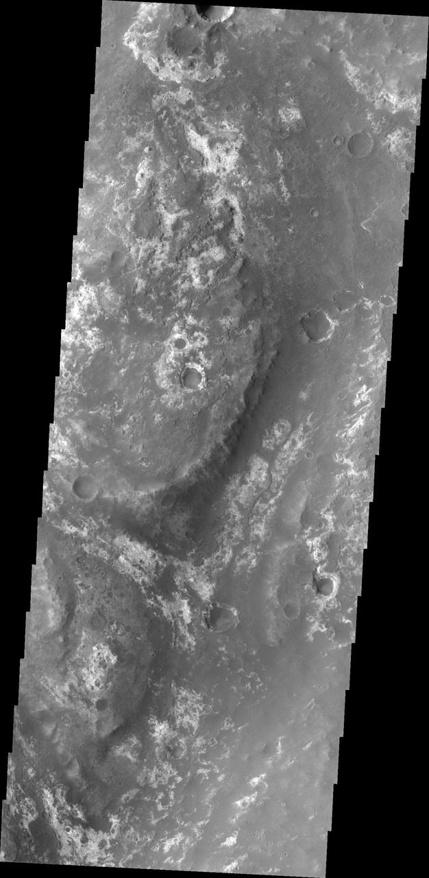 All this week, the THEMIS Image of the Day is following on the real Mars the path taken by fictional astronaut Mark Watney, stranded on the Red Planet in the book and movie, The Martian.  Today's image shows part of Mawrth Valles, a channel carved by giant floods billions of years ago. The highlands lying to the south and west of the channel are under consideration as a potential landing site for NASA's Mars 2020 rover. Remote-sensing observations from orbit show widespread exposures of clay minerals, indicating alteration by water early in Martian history. These might preserve traces of ancient life, if there was any.  For astronaut Mark Watney, driving in a pressurized and solar-powered rover vehicle, Mawrth Valles offers a gentle slope and an easy-to-follow route up from Acidalia's low-lying plains into the Arabia Terra highlands. At this point in his journey, he has driven about 750 kilometers (470 miles).  Orbit Number: 38563 Latitude: 24.4297 Longitude: 341.726 Instrument: VIS Captured: 2010-08-24 14:56  http://photojournal.jpl.nasa.gov/catalog/PIA19797