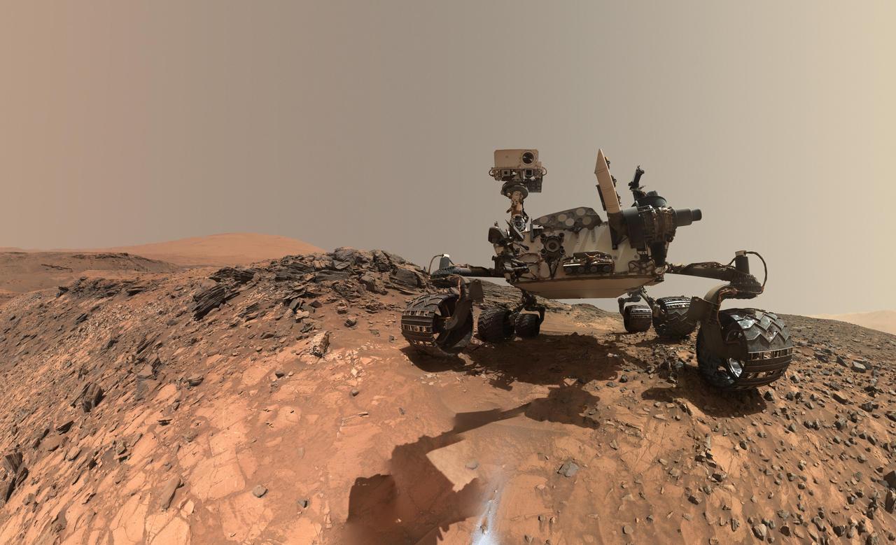 This low-angle self-portrait of NASA's Curiosity Mars rover shows the vehicle at the site from which it reached down to drill into a rock target called "Buckskin" on lower Mount Sharp. The selfie combines several component images taken by Curiosity's Mars Hand Lens Imager (MAHLI) on Aug. 5, 2015, during the 1,065th Martian day, or sol, of the rover's work on Mars. For scale, the rover's wheels are 20 inches (50 centimeters) in diameter and about 16 inches (40 centimeters) wide. This view is a portion of a larger panorama available at PIA19807. A close look reveals a small rock stuck onto Curiosity's left middle wheel (on the right in this head-on view). The rock had been seen previously during periodic monitoring of wheel condition about three weeks earlier, in the MAHLI raw image at http://mars.nasa.gov/msl/multimedia/raw/?rawid=1046MH0002640000400290E01_DXXX&s=1046. MAHLI is mounted at the end of the rover's robotic arm. For this self-portrait, the rover team positioned the camera lower in relation to the rover body than for any previous full self-portrait of Curiosity. This yielded a view that includes the rover's "belly," as in a partial self-portrait (/catalog/PIA16137) taken about five weeks after Curiosity's August 2012 landing inside Mars' Gale Crater. The selfie at Buckskin does not include the rover's robotic arm beyond a portion of the upper arm held nearly vertical from the shoulder joint. With the wrist motions and turret rotations used in pointing the camera for the component images, the arm was positioned out of the shot in the frames or portions of frames used in this mosaic. This process was used previously in acquiring and assembling Curiosity self-portraits taken at sample-collection sites "Rocknest" (PIA16468), "John Klein" (PIA16937), "Windjana" (PIA18390) and "Mojave" (PIA19142). MAHLI was built by Malin Space Science Systems, San Diego. NASA's Jet Propulsion Laboratory, a division of the California Institute of Technology in Pasadena, manages the Mars Science Laboratory Project for the NASA Science Mission Directorate, Washington. JPL designed and built the project's Curiosity rover. MAHLI was built by Malin Space Science Systems, San Diego. NASA's Jet Propulsion Laboratory, a division of the California Institute of Technology in Pasadena, manages the Mars Science Laboratory Project for the NASA Science Mission Directorate, Washington. JPL designed and built the project's Curiosity rover. http://photojournal.jpl.nasa.gov/catalog/PIA19808