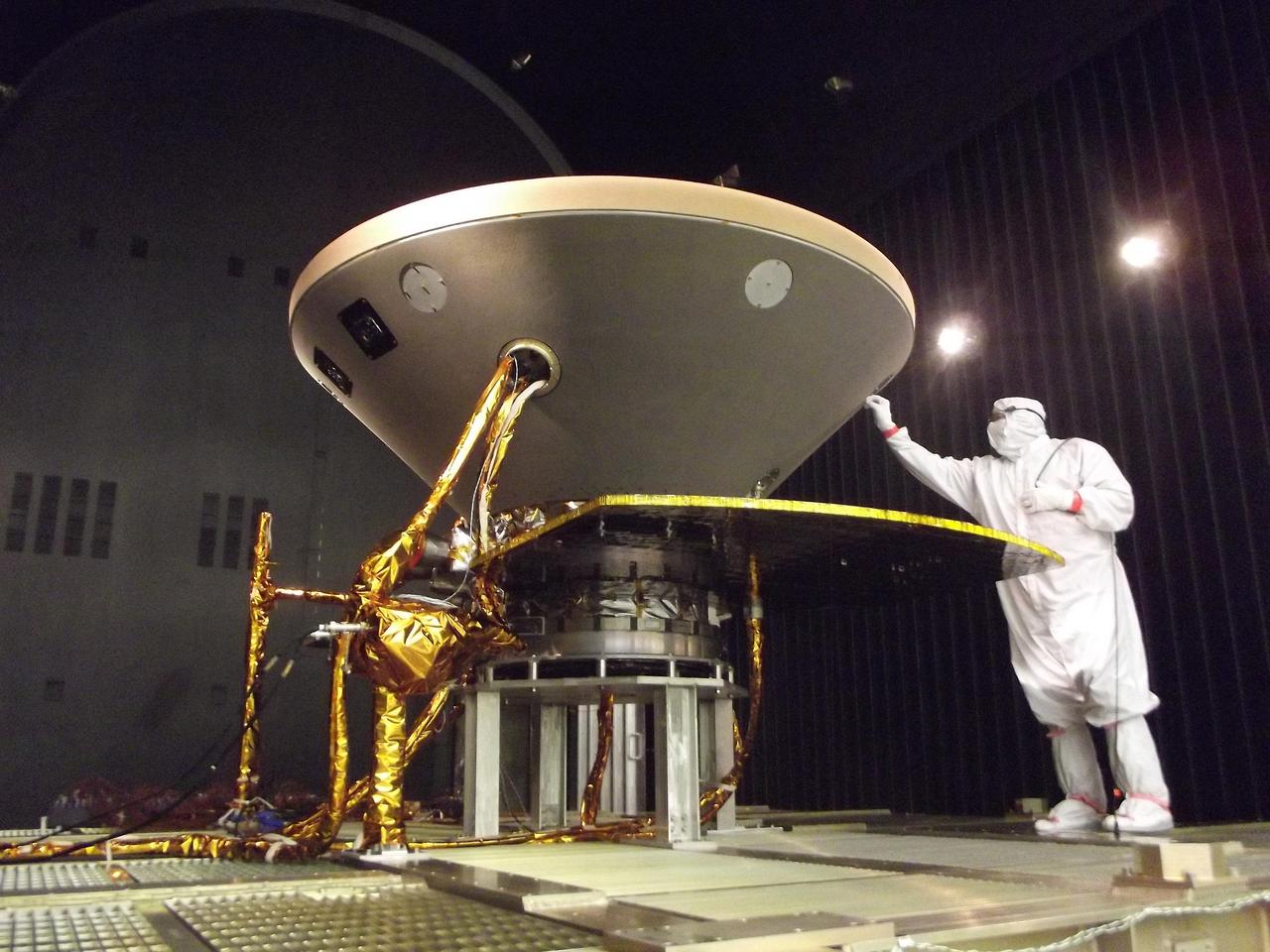 In this photo, a spacecraft specialist prepares NASA's InSight spacecraft for thermal vacuum testing in the flight system's "cruise" configuration for its 2016 flight to Mars. The testing simulates conditions of outer space that InSight will experience during its flight. The photo was taken on May 29, 2015, in a clean room of spacecraft assembly and test facilities at Lockheed Martin Space Systems, Denver. Note: After thorough examination, NASA managers have decided to suspend the planned March 2016 launch of the Interior Exploration using Seismic Investigations Geodesy and Heat Transport (InSight) mission. The decision follows unsuccessful attempts to repair a leak in a section of the prime instrument in the science payload. http://photojournal.jpl.nasa.gov/catalog/PIA19812