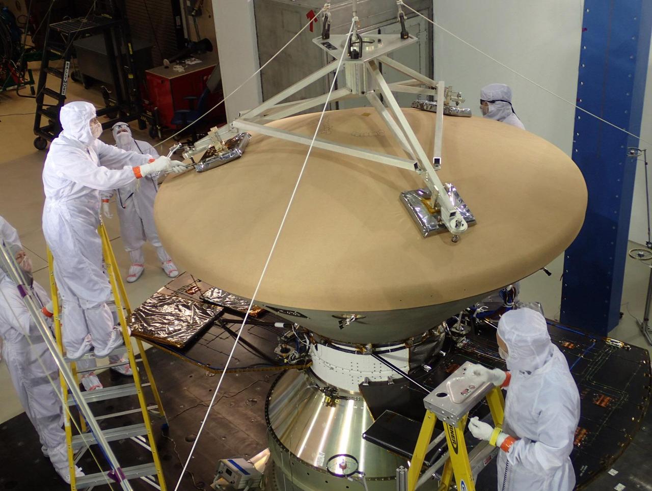 Spacecraft specialists at Lockheed Martin Space Systems, Denver, prepare NASA's InSight spacecraft for vibration testing as part of assuring that it is ready for the rigors of launch from Earth and flight to Mars. The spacecraft is oriented with its heat shield facing up in this July 13, 2015, photograph. InSight, for Interior Exploration Using Seismic Investigations, Geodesy and Heat Transport, is scheduled for launch in March 2016 and landing in September 2016. It will study the deep interior of Mars to advance understanding of the early history of all rocky planets, including Earth. Note: After thorough examination, NASA managers have decided to suspend the planned March 2016 launch of the Interior Exploration using Seismic Investigations Geodesy and Heat Transport (InSight) mission. The decision follows unsuccessful attempts to repair a leak in a section of the prime instrument in the science payload. http://photojournal.jpl.nasa.gov/catalog/PIA19815
