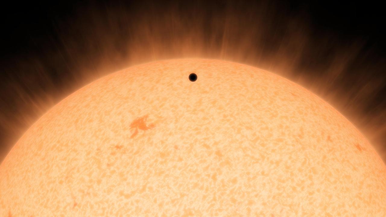 This artist's conception shows the silhouette of a rocky planet, dubbed HD 219134b, as it passes in front of its star. At 21 light-years away, the planet is the closest outside of our solar system that can be seen crossing, or transiting, its star -- a bonus for astronomers because transiting planets make ideal specimens for detailed studies of their atmospheres. It was discovered using the HARPS-North instrument on the Italian 3.6-meter National Galileo Telescope in the Canary Islands, and NASA's Spitzer Space Telescope.  The planet, which is about 1.6 times the size of Earth, is also the nearest confirmed rocky planet outside our solar system. It orbits a star that is cooler and smaller than our sun, whipping closely around it in a mere three days. The proximity of the planet to the star means that it would be scorching hot and not habitable.  Transiting planets are ideal targets for astronomers wanting to know more about planetary compositions and atmospheres. As a planet passes in front of its star, it causes the starlight to dim, and telescopes can measure this effect. If molecules are present in the planet's atmosphere, they can absorb certain wavelengths of light, leaving imprints in the starlight. This type of technique will be used in the future to investigate potentially habitable planets and search for signs of life.  http://photojournal.jpl.nasa.gov/catalog/PIA19831
