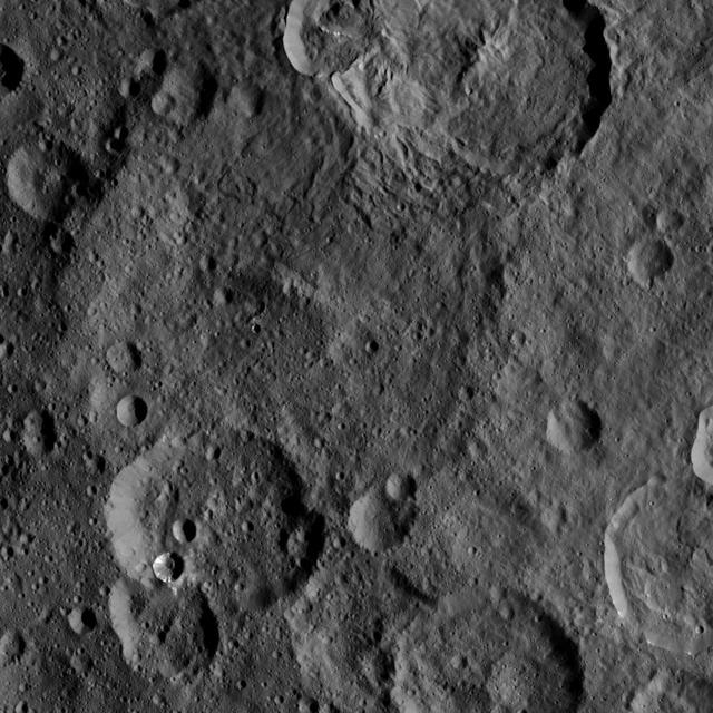 This image, taken by NASA's Dawn spacecraft, shows the surface of dwarf planet Ceres from an altitude of 915 miles (1,470 kilometers). The image, with a resolution of 450 feet (140 meters) per pixel, was taken on August 26, 2015.  http://photojournal.jpl.nasa.gov/catalog/PIA19896