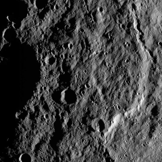 This image, taken by NASA's Dawn spacecraft, shows the surface of dwarf planet Ceres from an altitude of 915 miles (1,470 kilometers). The image, with a resolution of 450 feet (140 meters) per pixel, was taken on August 26, 2015.  http://photojournal.jpl.nasa.gov/catalog/PIA19897