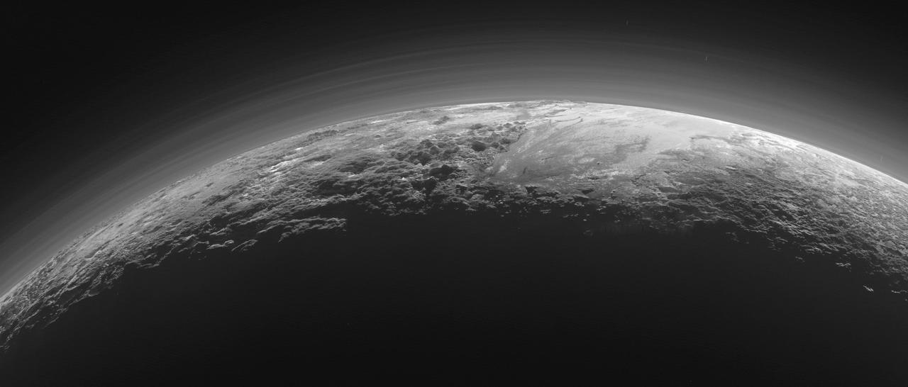 Just 15 minutes after its closest approach to Pluto on July 14, 2015, NASA's New Horizons spacecraft looked back toward the sun and captured this near-sunset view of the rugged, icy mountains and flat ice plains extending to Pluto's horizon. The smooth expanse of the informally named icy plain Sputnik Planum (right) is flanked to the west (left) by rugged mountains up to 11,000 feet (3,500 meters) high, including the informally named Norgay Montes in the foreground and Hillary Montes on the skyline. To the right, east of Sputnik, rougher terrain is cut by apparent glaciers. The backlighting highlights more than a dozen layers of haze in Pluto's tenuous but distended atmosphere. The image was taken from a distance of 11,000 miles (18,000 kilometers) to Pluto; the scene is 780 miles (1,250 kilometers) wide.   http://photojournal.jpl.nasa.gov/catalog/PIA19948