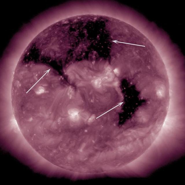 Three substantial coronal holes rotated across the face of the Sun the week of Sept. 8-10, 2015 as seen by NASA Solar Dynamics Observatory. Coronal holes are areas where the Sun magnetic field is open and a source of streaming solar wind. They appear darker in extreme ultraviolet light because there is less material in the hole areas being imaged in this specific wavelength of light. It is a little unusual to have three coronal holes at the same time, but neither is it a rare occurrence.  http://photojournal.jpl.nasa.gov/catalog/PIA19950