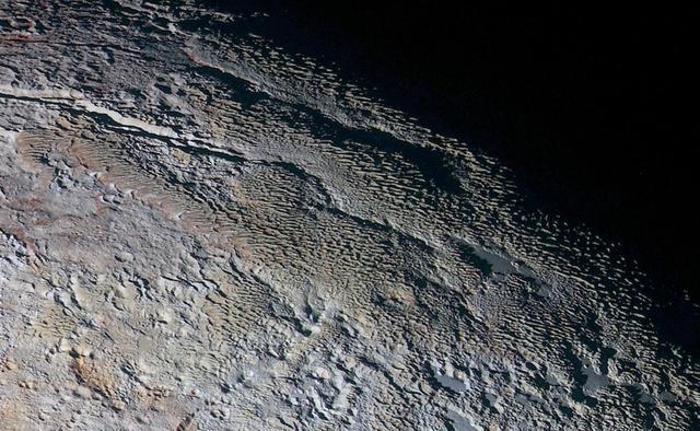 In this extended color image of Pluto taken by NASA New Horizons spacecraft, rounded and bizarrely textured mountains, informally named the Tartarus Dorsa, rise up along Pluto's day-night terminator and show intricate but puzzling patterns of blue-gray ridges and reddish material in between. This view, roughly 330 miles (530 kilometers) across, combines blue, red and infrared images taken by the Ralph/Multispectral Visual Imaging Camera (MVIC) on July 14, 2015, and resolves details and colors on scales as small as 0.8 miles (1.3 kilometers).   http://photojournal.jpl.nasa.gov/catalog/PIA19957
