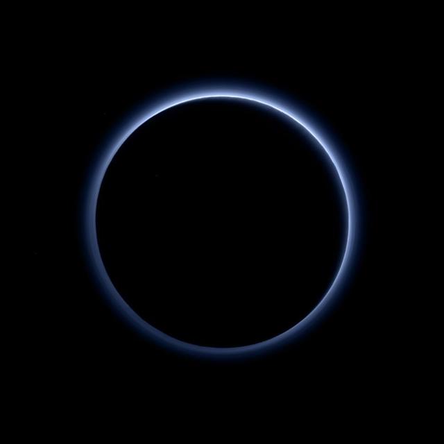 Pluto's haze layer shows its blue color in this picture taken by the New Horizons Ralph/Multispectral Visible Imaging Camera (MVIC). The high-altitude haze is thought to be similar in nature to that seen at Saturn's moon Titan. The source of both hazes likely involves sunlight-initiated chemical reactions of nitrogen and methane, leading to relatively small, soot-like particles (called tholins) that grow as they settle toward the surface. This image was generated by software that combines information from blue, red and near-infrared images to replicate the color a human eye would perceive as closely as possible.  http://photojournal.jpl.nasa.gov/catalog/PIA19964