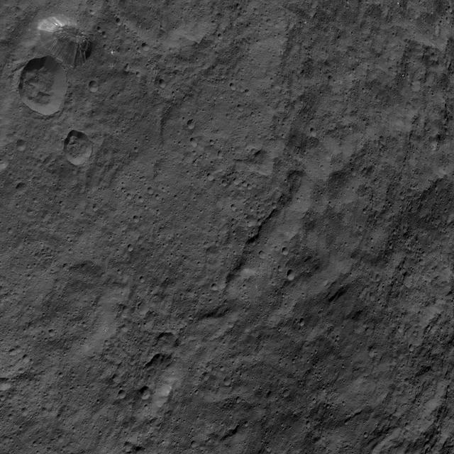 This image, taken by NASA's Dawn spacecraft, shows the surface of dwarf planet Ceres from an altitude of 915 miles (1,470 kilometers) around mid-latitudes. The image was taken on Sept. 28, 2015, and has a resolution of 450 feet (140 meters) per pixel.  The unusual mountain Ahuna Mons is featured in this image, named for the traditional post-harvest festival of the Sumi tribe of Nagaland, India. It is 4 miles (6 kilometers) tall and 12 miles (20 kilometers) in diameter.   http://photojournal.jpl.nasa.gov/catalog/PIA19995