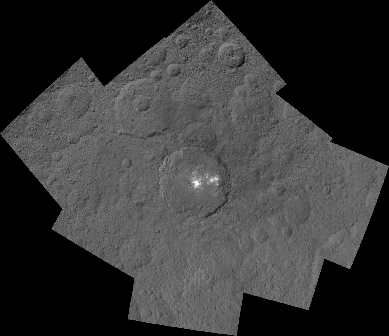 This mosaic shows Ceres' Occator crater and surrounding terrain from an altitude of 915 miles (1,470 kilometers), as seen by NASA's Dawn spacecraft. Occator is 60 miles (90 kilometers) across and 2 miles (4 kilometers) deep.  Occator is home to the brightest area on Ceres, which tends to appear overexposed in most images. This view uses a composite of two images of Occator: one using a short exposure that captures the detail in the bright spots, and one where the background surface is captured at normal exposure.  The images used to make this mosaic have a resolution of 450 feet (140 meters) per pixel, and were taken during the first of six mapping cycles during Dawn's high-altitude mapping orbit.   http://photojournal.jpl.nasa.gov/catalog/PIA19996
