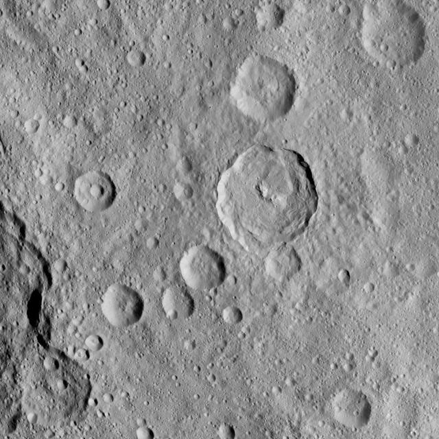 This image of Ceres, taken by NASA Dawn spacecraft, shows a 23-mile-wide 37 kilometer-wide crater called Tupo, which features a curved central peak complex and terraces. The rim of the degraded crater Darzamat (58 miles, 94 kilometers wide) is visible on the lower left border of the image.  The image was taken on Oct. 2, 2015, from an altitude of 915 miles (1,470 kilometers), and has a resolution of 450 feet (140 meters) per pixel. The image is centered at approximately 36 degrees south latitude, 86 degrees east longitude.  http://photojournal.jpl.nasa.gov/catalog/PIA19999