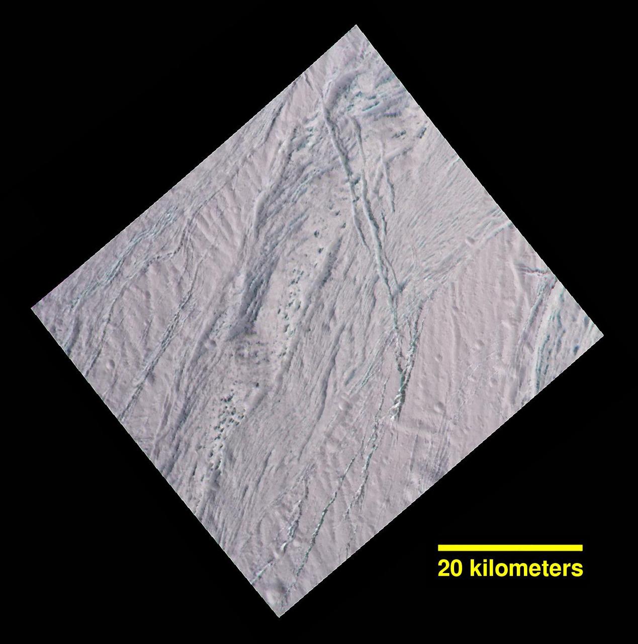 During its final close flyby of Saturn's moon Enceladus, NASA's Cassini spacecraft revisited a landscape, and a mystery, that it had originally glimpsed more than 10 years earlier.  In views of this terrain captured during a 2005 flyby (see PIA06188), imaging scientists noticed small dark spots of an uncertain nature. Observing the same features in this false-color view, at higher resolution than before, provides some new insights. The spots are evidently large, relatively dark protrusions of solid "bedrock" ice and ice blocks scattered on and around the prominent ridge that runs across the scene from north to south (from top center toward lower left). The ice blocks range in size from dozens to hundreds of feet (tens to hundreds of meters).  The false-color view uses an ultraviolet filter centered at 338 nanometers for blue, a green filter centered at 568 nanometers for green and a near-infrared filter centered at 930 nanometers for red -- thus covering a wider spectrum region than the human eye.  As in earlier Cassini views of Enceladus using the same combination of color filters (see PIA06254), green-hued features represent coarse-grained or solid ice. Exposures of these kinds of ices are also found on the walls of cracks and troughs in this scene and elsewhere on Enceladus.  To an observer on the surface, the prominent north-south trending ridge might look superficially like icy flatirons (tilted, triangular outcroppings of rock), but probably more shallowly dipping than terrestrial examples. The exposed line of ice blocks along its ridge crest might make it look a bit like a hogback (a narrow ridge with steep sides, often with vertical rocky outcrops along the top).  On Enceladus, with no wind to scour loose particulate ice or "snow" off of them, the solid blocks are probably cleared by some combination of downslope movement of particulates, and perhaps sublimation.  This image has a spatial scale of about 220 feet (67 meters) per pixel at its center, which is nearly twice the resolution of the earlier view (PIA06188).  This terrain is on the moon's Saturn-facing side, a few degrees south of the equator. The view has been rotated so that north on Enceladus is up. The view was obtained by the Cassini spacecraft narrow-angle camera on Dec. 19, 2015.  http://photojournal.jpl.nasa.gov/catalog/PIA20017