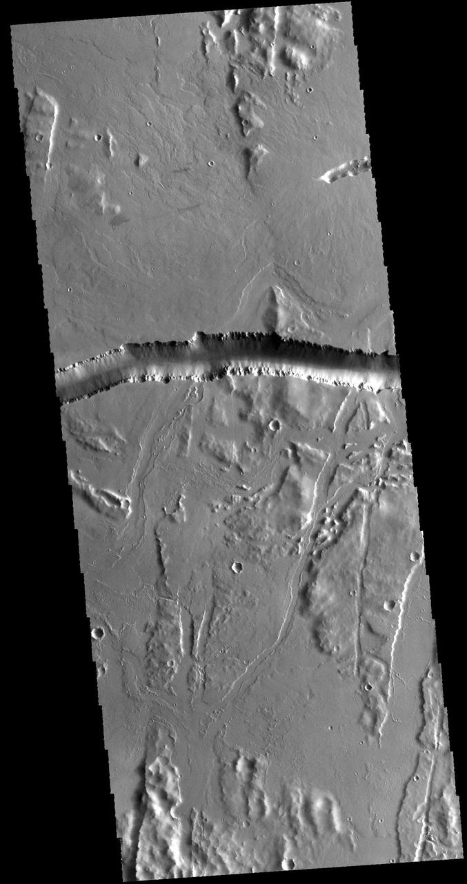 The depression crossing this VIS image is a lava channel called Olympica Fossae. It is located on lava plains between Alba Mons and Olympus Mons. Orbit Number: 60743 Latitude: 25.7077 Longitude: 247.589 Instrument: VIS Captured: 2015-08-24 08:06 http://photojournal.jpl.nasa.gov/catalog/PIA20071