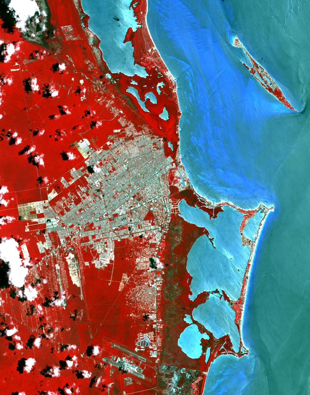 This image from NASA Terra spacecraft shows Cancun, a resort city on the east side of Mexico Yucatan Peninsula. In 1970, the population was 120 people. The city began as a tourism project in 1974. Since then, it has undergone a comprehensive transformation from being a fisherman's island surrounded by virgin forest and undiscovered shores to being one of the two most well-known Mexican resorts, along with Acapulco. In 1990 the city had grown to 167,000 inhabitants, and by 2014 to 723,000 inhabitants. These two images show the area on March 28, 1985, acquired by Landsat; and May 14, 2014, acquired by ASTER. The images cover an area of 25 x 36 km, and are located at 21.1 degrees north, 86.8 degrees west.   http://photojournal.jpl.nasa.gov/catalog/PIA20086