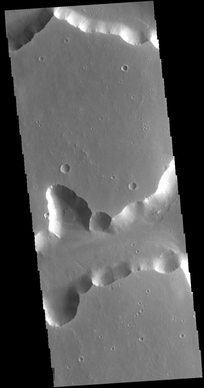 The steep sided depressions in this image captured by NASA 2001 Mars Odyssey spacecraft are fault bounded tectonic features called graben. These depressions are part of a large region of graben called Sacra Fossae. Sacra Fossae is located on the western margin of Lunae Planum. Orbit Number: 60829 Latitude: 18.2961 Longitude: 287.711 Instrument: VIS Captured: 2015-08-31 10:01 http://photojournal.jpl.nasa.gov/catalog/PIA20094