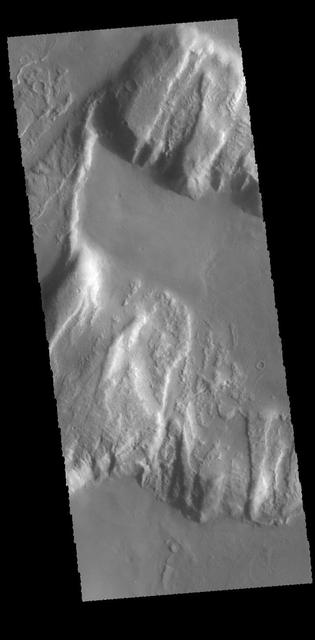 This image from NASA 2001 Mars Odyssey spacecraft shows the northern margin of Tanaica Montes. These hills are cut by fractures, which are in alignment with the regional trend of tectonic faulting found east of Alba Mons.  Orbit Number: 61129 Latitude: 40.1468 Longitude: 269.641 Instrument: VIS Captured: 2015-09-25 03:03
