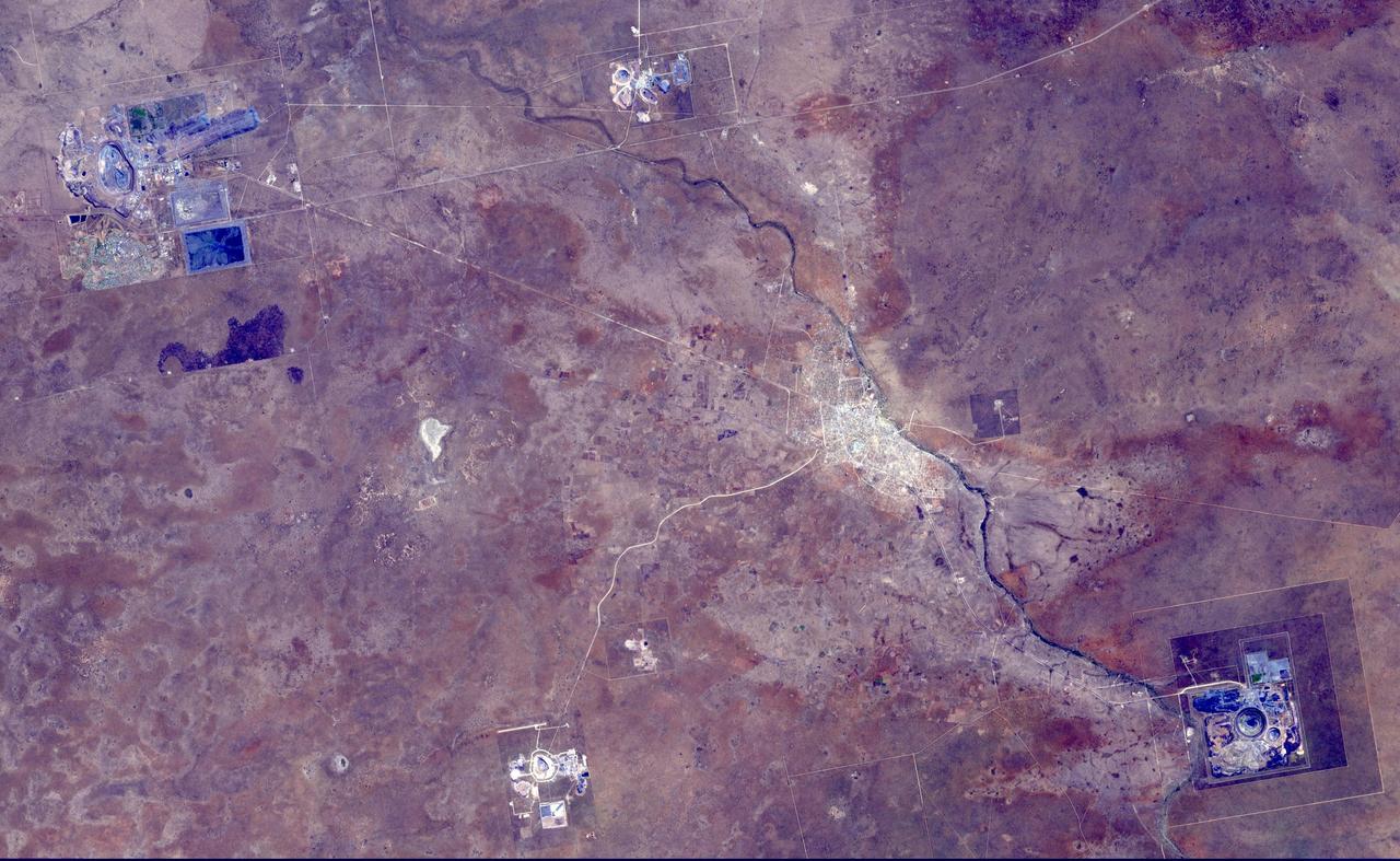This image from NASA Terra spacecraft shows the Orapa diamond mine, the world largest diamond mine by area. The mine is located in Botswana. It is the oldest of four mines operated by the same company, having begun operations in 1971. Orapa is an open pit style of mine, located on two kimberlite pipes. Currently, the Orapa mine annually produces approximately 11 million carats (2200 kg) of diamonds. The Letlhakane diamond mine is also an open pit construction. In 2003, the Letlhakane mine produced 1.06 million carats of diamonds. The Damtshaa diamond mine is the newest of four mines, located on top of four distinct kimberlite pipes of varying ore grade. The mine is forecast to produce about 5 million carats of diamond over the projected 31 year life of the mine. The image was acquired October 5, 2014, covers an area of 28 by 45 km, and is located at 21.3 degrees south, 25.4 degrees east. http://photojournal.jpl.nasa.gov/catalog/PIA20104