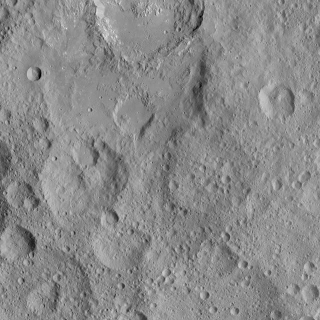 This view shows cratered terrain in the northern hemisphere of Ceres. Ikapati crater is partially cut off at the top of the scene. It appears to have flat plains in its interior that were filled by flows, and it is surrounded by smooth material and ejecta from the crater’s interior. On the crater floor are clusters of small pits, some surrounded by bright material. NASA's Dawn spacecraft took this image on Oct. 6, 2015, from an altitude of 915 miles (1,470 kilometers). It has a resolution of 450 feet (140 meters) per pixel. The image is located at 36 degrees north latitude, 43 degrees east longitude. http://photojournal.jpl.nasa.gov/catalog/PIA20127