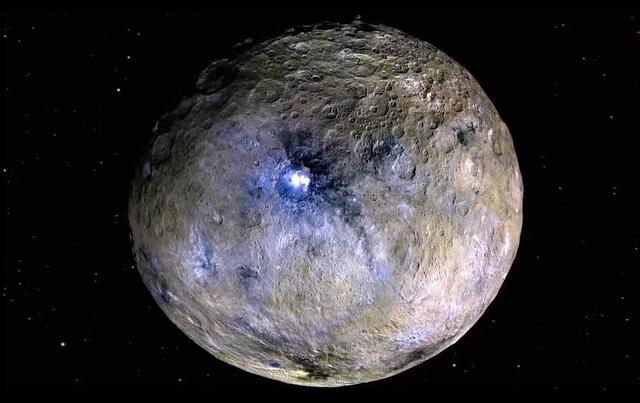 This frame from a video from NASA's Dawn mission shows dwarf planet Ceres in false-color renderings, which highlight differences in surface materials. Images were used to create a movie of Ceres rotating, followed by a flyover view of Occator Crater, home of Ceres' brightest area.  A video is available at http://photojournal.jpl.nasa.gov/catalog/PIA20182