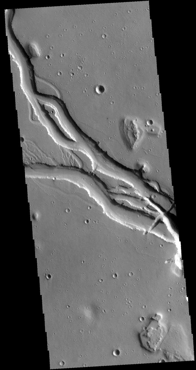 This image captured by NASA 2001 Mars Odyssey spacecraft shows a portion of Hebrus Valles. This channel system was formed by liquid flow of either water or lava, or a combination of both. There is a streamlined island in this image and channels at several different elevations. Orbit Number: 61733 Latitude: 17.9819 Longitude: 127.921 Instrument: VIS Captured: 2015-11-13 20:40 http://photojournal.jpl.nasa.gov/catalog/PIA20234