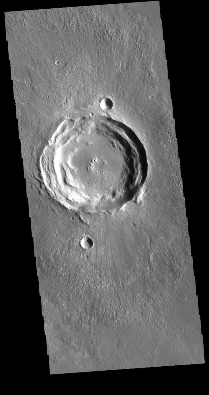 This image captured by NASA 2001 Mars Odyssey spacecraft shows an unnamed crater near Acheron Fossae. The structure of this crater includes a central pit and several concentric rims. Radial grooves can be seen on the ejecta blanket surrounding the crater. Orbit Number: 61879 Latitude: 36.8829 Longitude: 232.325 Instrument: VIS Captured: 2015-11-25 21:21 http://photojournal.jpl.nasa.gov/catalog/PIA20240