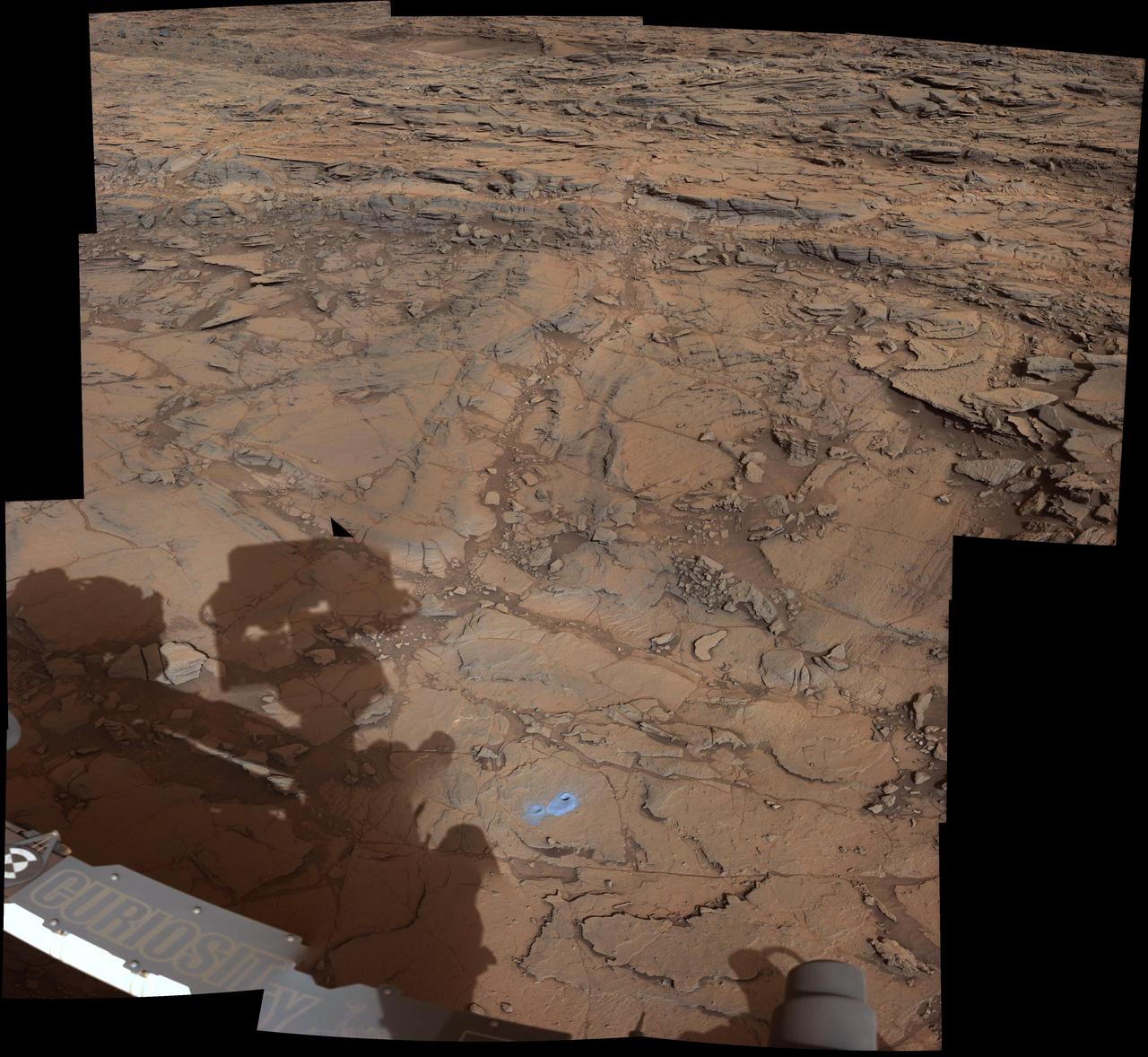 This view from the Mast Camera (Mastcam) on NASA's Curiosity Mars rover covers an area in "Bridger Basin" that includes the locations where the rover drilled a target called "Big Sky" on the mission's Sol 1119 (Sept. 29, 2015) and a target called "Greenhorn" on Sol 1137 (Oct. 18, 2015).  The scene combines portions of several observations taken from sols 1112 to 1126 (Sept. 22 to Oct. 6, 2015) while Curiosity was stationed at Big Sky drilling site. The Big Sky drill hole is visible in the lower part of the scene. The Greenhorn target, in a pale fracture zone near the center of the image, had not yet been drilled when the component images were taken. Researchers selected this pair of drilling sites to investigate the nature of silica enrichment in the fracture zones of the area. http://photojournal.jpl.nasa.gov/catalog/PIA20270