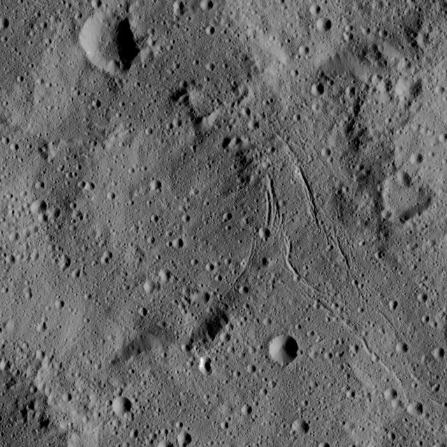 This view from NASA's Dawn spacecraft captures gently curving canyons amid cratered plains on Ceres. The image is centered at approximately 31 degrees south latitude, 259 degrees east longitude, just north of the large crater Urvara.  Dawn captured the scene on Dec. 19, 2015 from its low-altitude mapping orbit (LAMO), at an approximate altitude of 240 miles (385 kilometers) above Ceres. The image resolution is 120 feet (35 meters) per pixel.  http://photojournal.jpl.nasa.gov/catalog/PIA20299