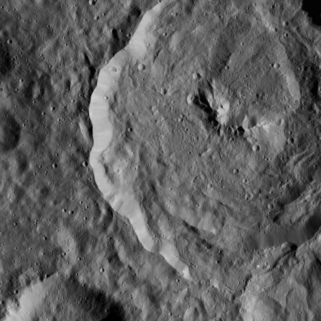 Tupo Crater on Ceres is seen in this view from NASA Dawn spacecraft. This crater, located in the southern hemisphere of Ceres, was named for the Polynesian god of turmeric. Dawn captured the scene on Dec. 24, 2015.