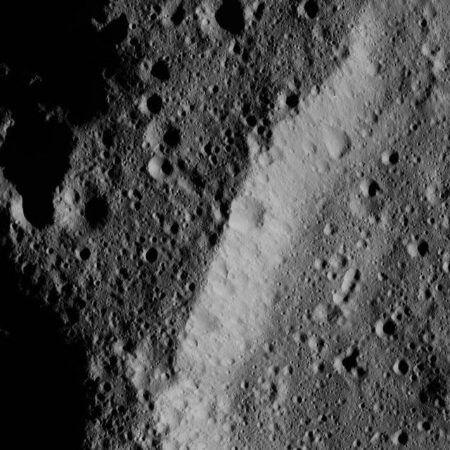 This image, taken by NASA Dawn spacecraft, shows the heavily cratered rim of an older, unnamed impact feature on Ceres. The crater density is almost the same inside and outside, and its wall is also quite battered by impacts.