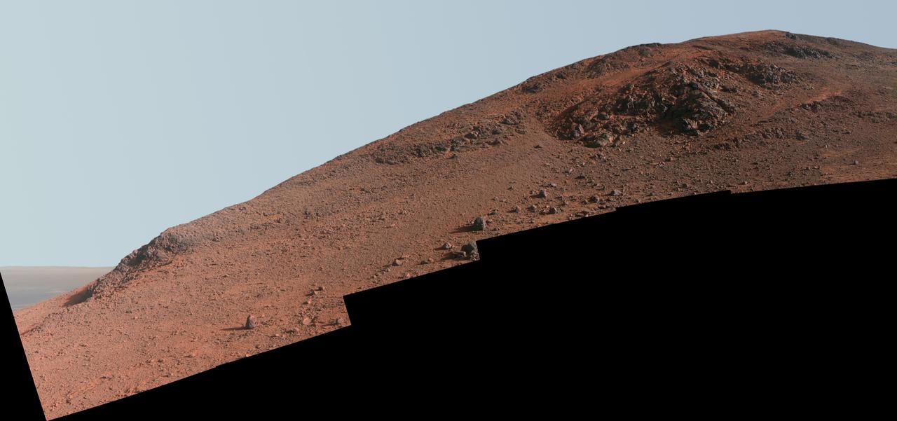 This scene in enhanced color from NASA Mars Exploration Rover Opportunity looks upward at Knudsen Ridge on the southern edge of Marathon Valley from inside the valley.