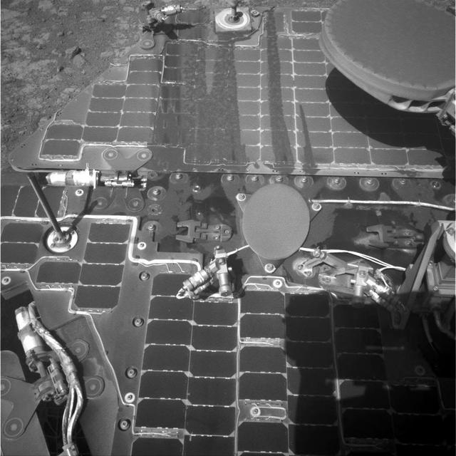 This image from the navigation camera on the mast of NASA Mars Exploration Rover Opportunity shows streaks of dust or sand on the vehicle rear solar panel after a series of drives during which the rover was pointed steeply uphill.