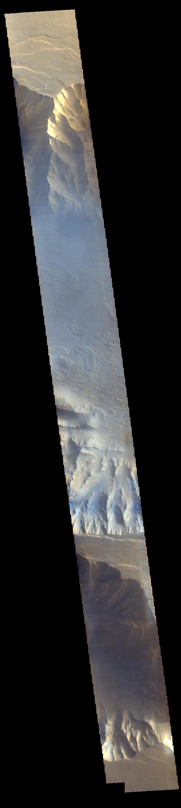 Light blue clouds fill Coprates Chasma on Mars, part of Valles Marineris, the vast Grand Canyon of Mars. The clouds are mostly ice crystals and they appear blue in color in this image from NASA Mars Odyssey.