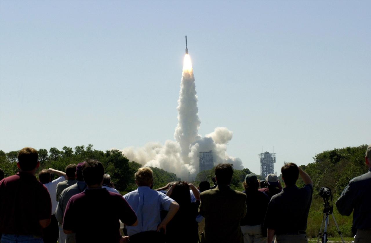 At 11:02 a.m. EDT on April 7, 2001, crowds watch a Boeing Delta II rocket lift off from Cape Canaveral Air Force Station, Florida, carrying NASA 2001 Mars Odyssey spacecraft into space on its seven-month journey to Mars.