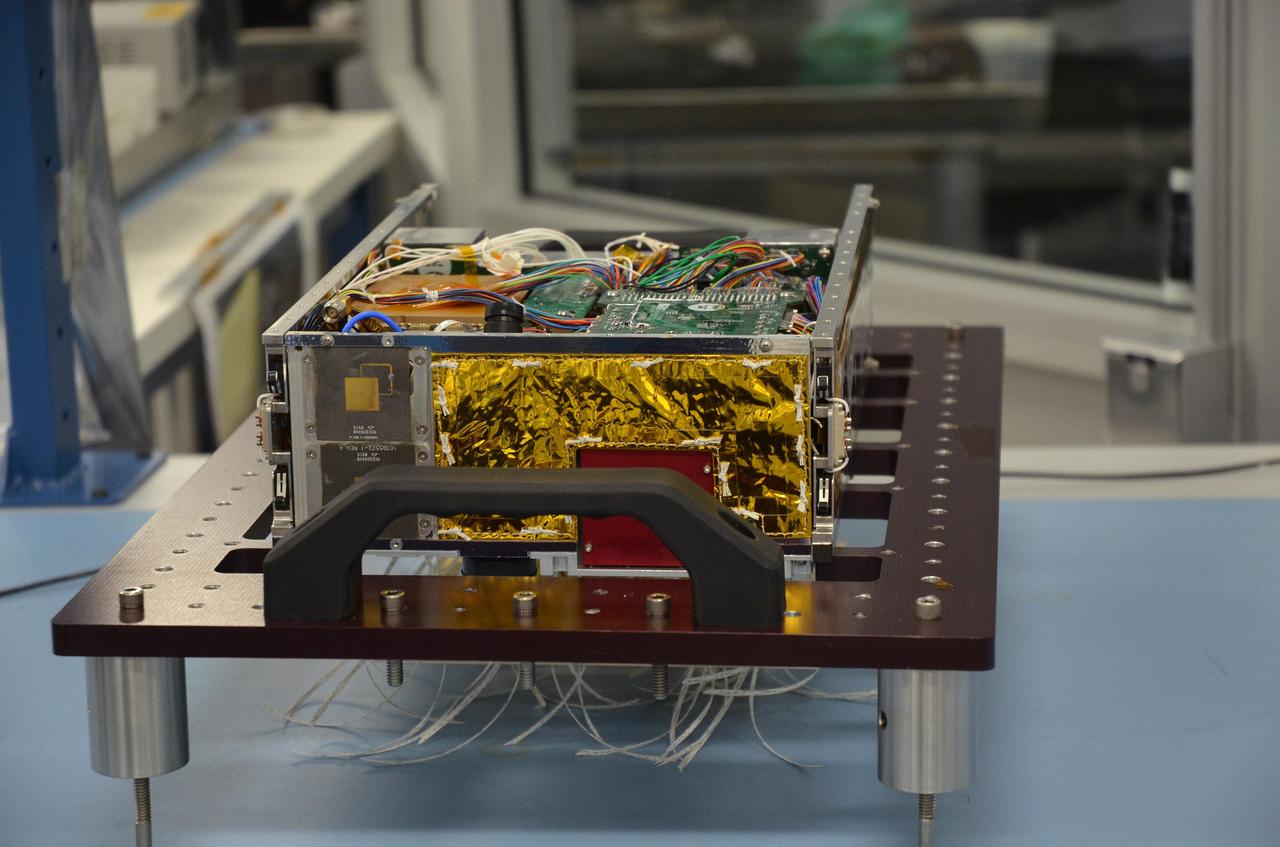 One of the two MarCO (Mars Cube One) CubeSat spacecraft, with its insides displayed, is seen at NASA's Jet Propulsion Laboratory, Pasadena, California.  The briefcase-size MarCO twins were designed to ride along with NASA's next Mars lander, InSight. Its planned March 2016 launch was suspended.  InSight -- an acronym for Interior Exploration using Seismic Investigations, Geodesy and Heat Transport -- will study the interior of Mars to improve understanding of the processes that formed and shaped rocky planets, including Earth.  Note: After thorough examination, NASA managers have decided to suspend the planned March 2016 launch of the Interior Exploration using Seismic Investigations Geodesy and Heat Transport (InSight) mission. The decision follows unsuccessful attempts to repair a leak in a section of the prime instrument in the science payload.  http://photojournal.jpl.nasa.gov/catalog/PIA20345