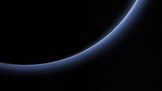 This processed image is the highest-resolution color look yet at the haze layers in Pluto's atmosphere. Shown in approximate true color, the picture was constructed from a mosaic of four panchromatic images from the Long Range Reconnaissance Imager (LORRI) splashed with Ralph/Multispectral Visible Imaging Camera (MVIC) four-color filter data, all acquired by NASA's New Horizons spacecraft on July 14, 2015. The resolution is 1 kilometer (0.6 miles) per pixel; the sun illuminates the scene from the right.  Scientists believe the haze is a photochemical smog resulting from the action of sunlight on methane and other molecules in Pluto's atmosphere, producing a complex mixture of hydrocarbons such as acetylene and ethylene. These hydrocarbons accumulate into small particles, a fraction of a micrometer in size, and scatter sunlight to make the bright blue haze seen in this image.  As they settle down through the atmosphere, the haze particles form numerous intricate, horizontal layers, some extending for hundreds of miles around Pluto. The haze layers extend to altitudes of over 200 kilometers (120 miles).  Adding to the stark beauty of this image are mountains on Pluto's limb (on the right, near the 4 o'clock position), surface features just within the limb to the right, and crepuscular rays (dark finger-like shadows to the left) extending from Pluto's topographic features.  http://photojournal.jpl.nasa.gov/catalog/PIA20362