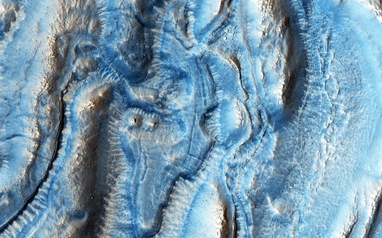 This image was taken in one of the regions on Mars well-known for its viscous flow features (VFF), which are massive flowing deposits believed to be composed of a mixture of ice and dust similar to glaciers on Earth.  In this particular region, an impact event occurred creating ejecta deposits that also appear to flow (probably because of their similarly ice-rich composition), and interact with the flows from the VFF. Looking closer, we can see that the VFF deposits (on the right) appear to be rougher in appearance than those of the impact ejecta.  We will need to study this image in more detail to understand how these flows have interacted with each other and what they can tell us about their composition and their flowing behavior properties.  http://photojournal.jpl.nasa.gov/catalog/PIA20370