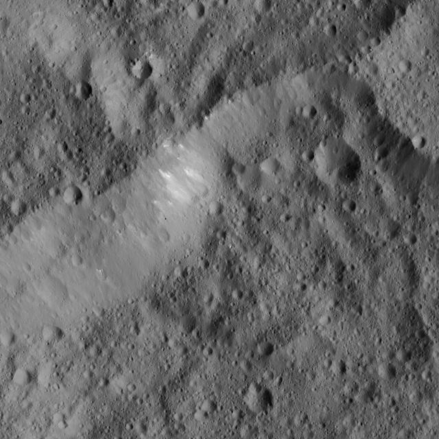 This scene from Ceres, captured by NASA Dawn spacecraft, shows an older crater at top center that has been blanketed by impact ejecta from the younger crater to its right.