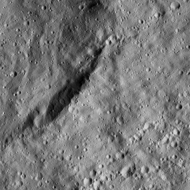 The view from NASA Dawn spacecraft shows an unnamed crater that lies in the northeast part of the larger impact feature Gaue. The area is dominated by small craters and is relatively smooth in general.