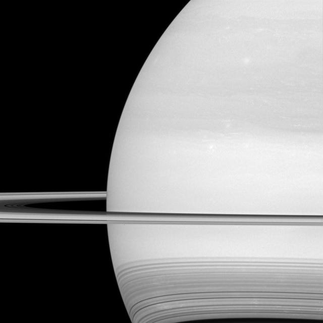NASA's Cassini spacecraft looks toward the brilliant disk of Saturn, surrounded by the icy lanes of its rings. Faint wisps of cloud are visible in the atmosphere. At bottom, ring shadows trace delicate, curving lines across the planet. Prometheus (53 miles or 86 kilometers across) is just a few pixels wide in this view, barely visible as a dark speck in front of the planet, below the rings and to the left of center. Between April and September 2017, Cassini will plunge repeatedly through the gap that separates the planet from the rings. This view looks toward the sunlit side of the rings from about a degree above the ring plane. The image was taken in green light with the Cassini spacecraft wide-angle camera on July 21, 2016. The view was obtained at a distance of approximately 529,000 miles (852,000 kilometers) from Saturn and at a sun-Saturn-spacecraft, or phase, angle of 37 degrees. Image scale is 30 miles (50 kilometers) per pixel. http://photojournal.jpl.nasa.gov/catalog/PIA20500