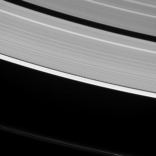 Saturn's moon Daphnis raises waves wherever it goes. In fact, such waves are one way that scientists search for undiscovered moons in the ring gaps. But they can tell researchers a lot of other things, as well. The waves that Daphnis (5 miles or 8 kilometers across) raises on the edges of the Keeler Gap can also be used to deduce the moon's mass and even some of its orbital behavior. Since the moon moves in and out of the ring-plane, and closer to and farther from the rings' edges as it orbits, the waves it makes change over time. Cassini has been observing these changes during its extended study of the Saturn system to help understand this interaction. This view looks toward the sunlit side of the rings from about 35 degrees above the ring plane. The image was taken in visible light with the Cassini spacecraft narrow-angle camera on Oct. 10, 2016. Daphnis has been brightened by a factor of two in this image to increase its visibility. The view was obtained at a distance of approximately 810,000 miles (1.3 million kilometers) from Daphnis and at a Sun-Daphnis-spacecraft, or phase, angle of 96 degrees. Image scale is 5 miles (8 kilometers) per pixel. http://photojournal.jpl.nasa.gov/catalog/PIA20511