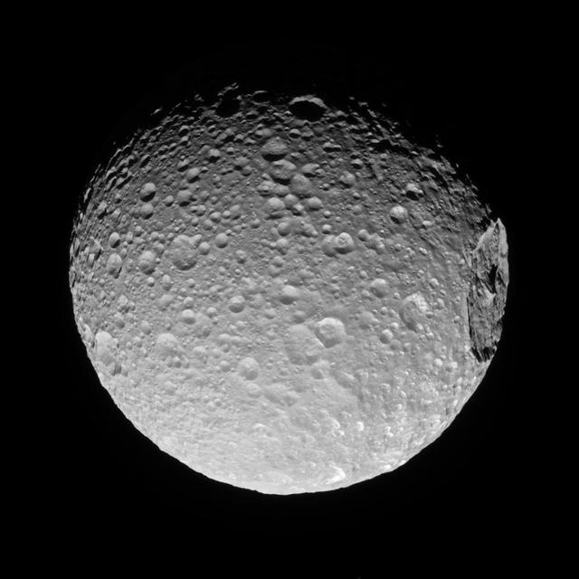 Mimas' gigantic crater Herschel lies near the moon's limb in this Cassini view.  A big enough impact could potentially break up a moon. Luckily for Mimas, whatever created Herschel was not quite big enough to cause that level of disruption.  When large impacts happen, they deliver tremendous amounts of energy -- sometimes enough to cause global destruction. Even impacts that are not catastrophic can leave enormous, near-permanent scars on bodies like Mimas (246 miles or 396 kilometers across).  This view looks toward the anti-Saturn hemisphere of Mimas. North on Mimas is up and rotated 32 degrees to the left. The image was taken in visible light with the Cassini spacecraft narrow-angle camera on Nov. 19, 2016.  The view was acquired at a distance of approximately 53,000 miles (85,000 kilometers) from Mimas. Image scale is 1,677 feet (511 meters) per pixel.  http://photojournal.jpl.nasa.gov/catalog/PIA20523